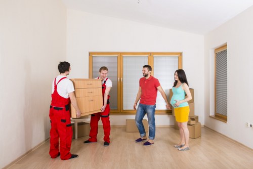 Local movers carrying furniture from a Crystal Palace property