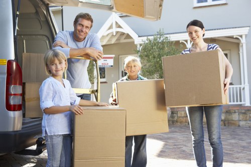 Moving team unloading boxes into a new home during a house removal